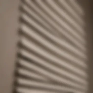 A close-up view of a pleated blind with dust accumulation