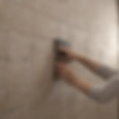 Close-up of tile being adhered to the wall