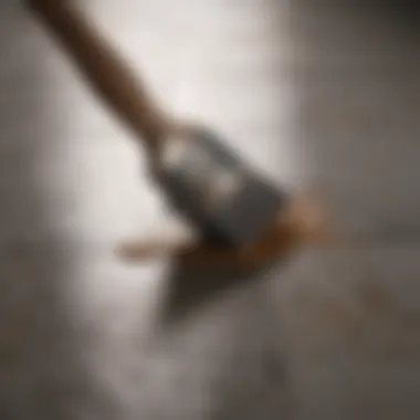 Close-up of a brush applying paint on tiles