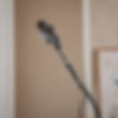 A user easily accessing their wall-mounted Shark cordless vacuum for quick cleaning.